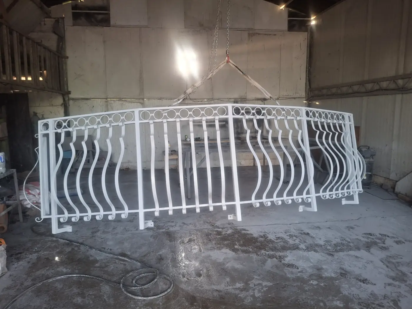 White-painted wrought iron railing in the workshop