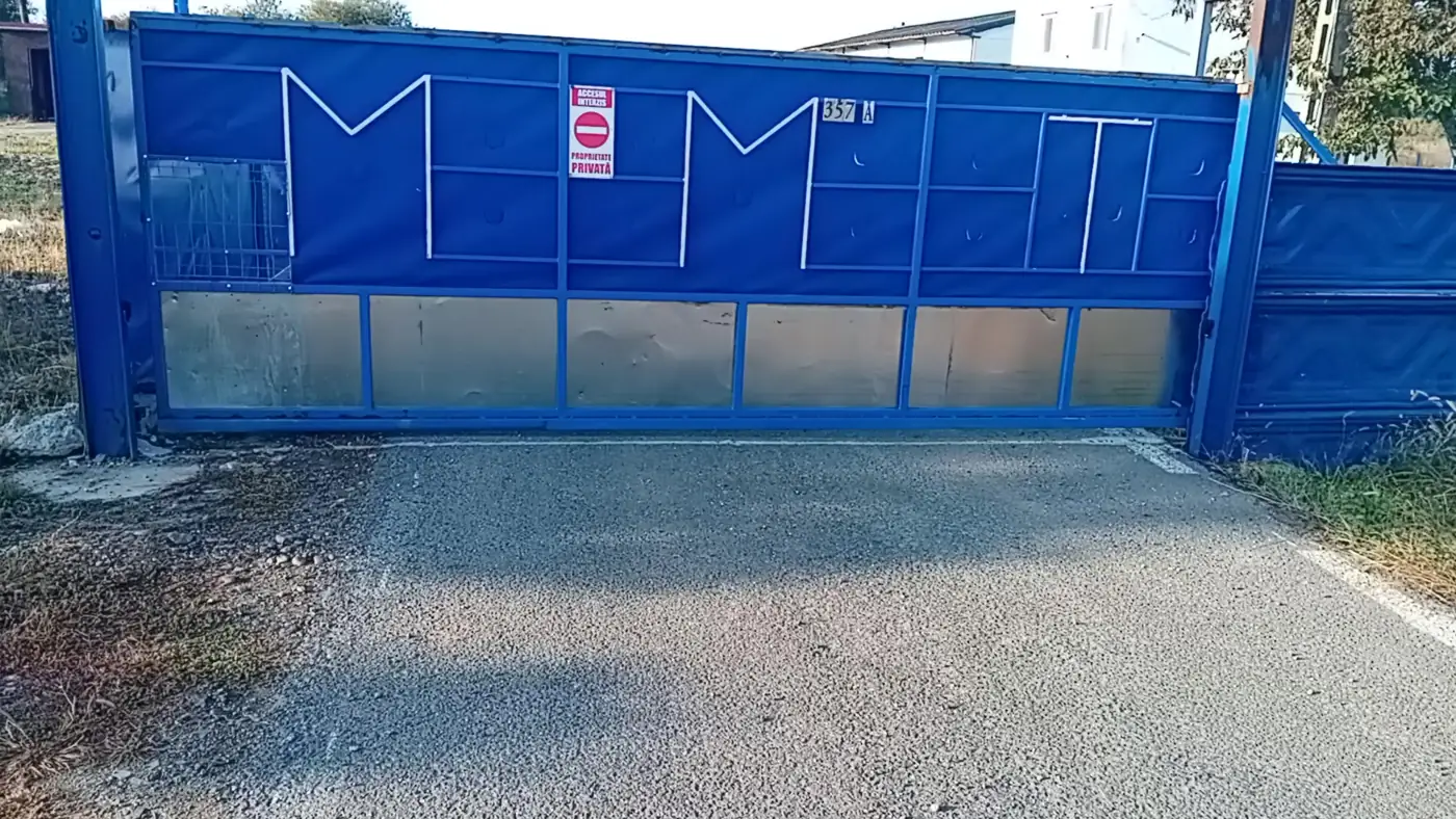 Closed metal sliding gate installed at a driveway entrance