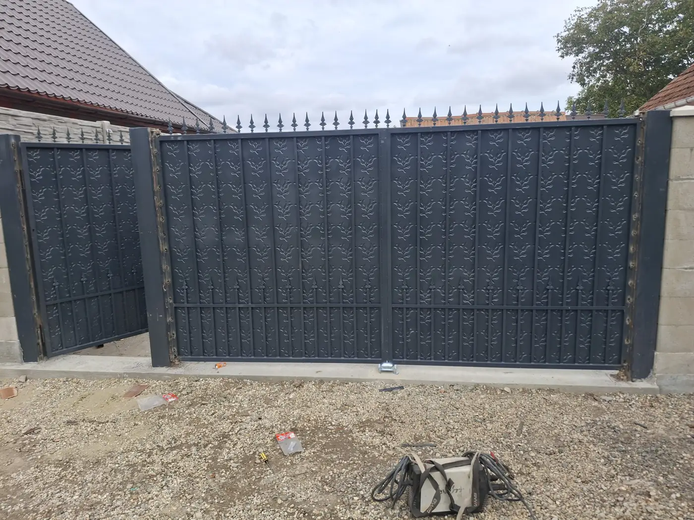 Metal gate and fence with decorative panels, installed for a client