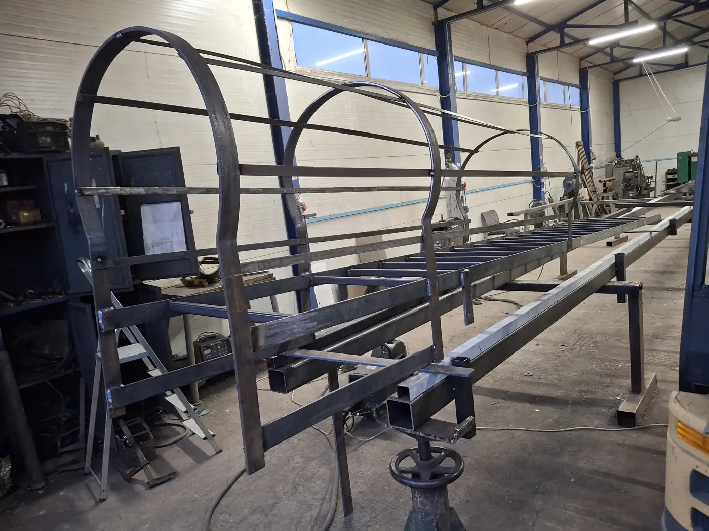 Arched steel structure being fabricated in the workshop