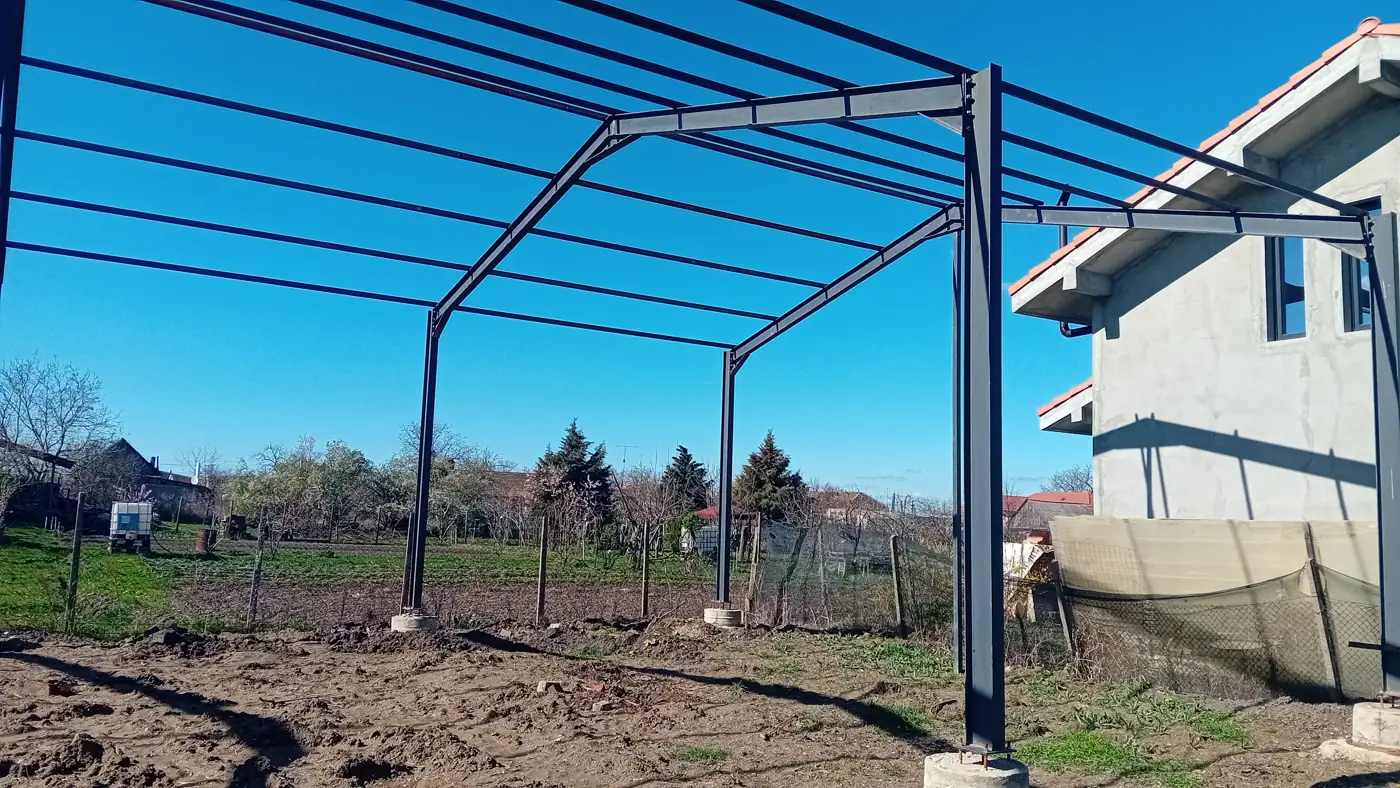 Steel carport structure installed next to a house
